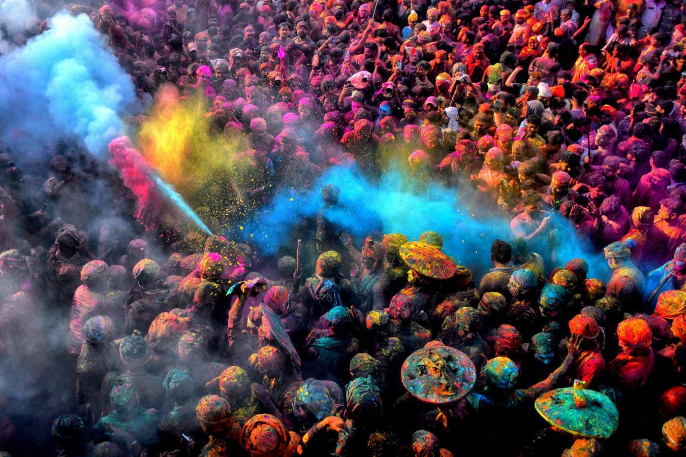 Mandatory Credit: Photo by Avishek Das/SOPA Images/Shutterstock (15187904m) Hindu devotees play with water and colorful powder (Gulal) at the Radharani Temple of Nandgaon during the Holi festival. Holi Festival of India is one of the biggest colorful celebrations in India as many tourists and devotees gather to observe this colorful event, which marks the beginning of spring. The festival celebrates the divine love of Radha and Krishna and represents the victory of good over evil. Holi Celebration at Nandgaon, India - 09 Mar 2025