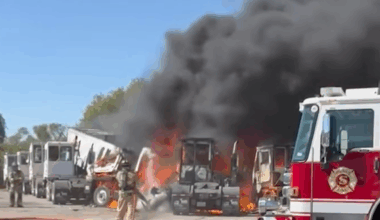 Two dead after plane crashes into trailers near Texas airfields as nearby building goes up in flames