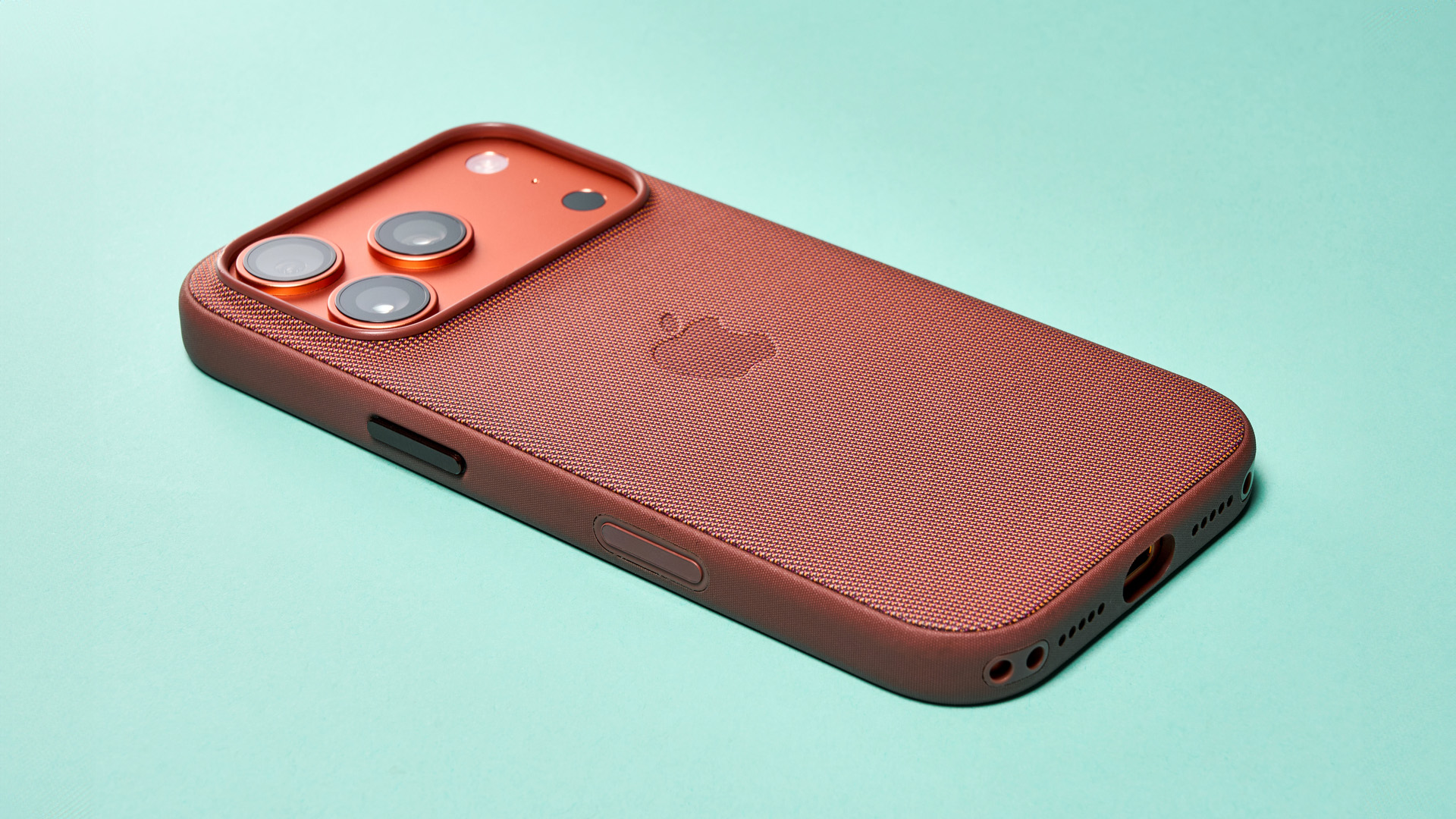 Apple iPhone 17 Pro in cosmic orange on green background