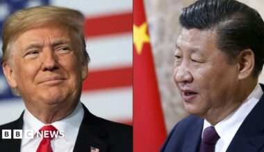 Donald Trump raises his right fist as he exits Air Force One in Kuala Lumpur