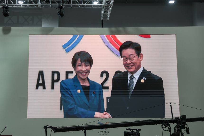 A broadcast shows Japanese Prime Minister Sanae Takaichi being greeted by South Korean President Lee Jae Myung, during the sideline meeting of the Asia-Pacific Economic Cooperation (APEC) summit in Gyeongju, South Korea, on October 30, 2025.
