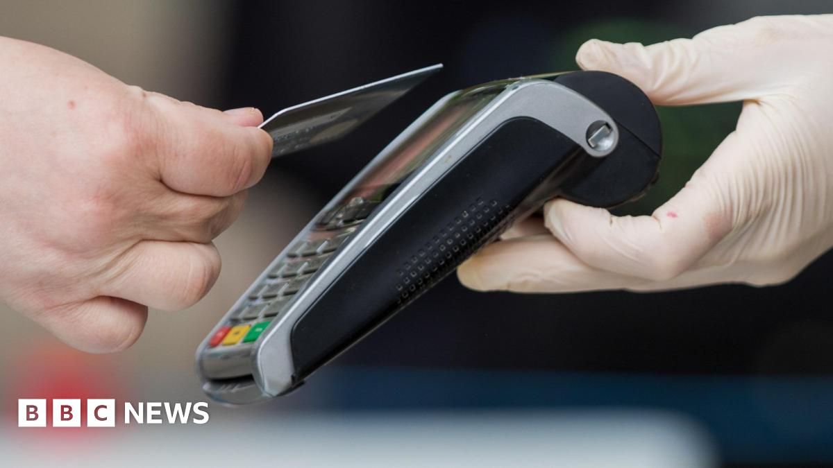 A person tapping their bank card on a card reader.