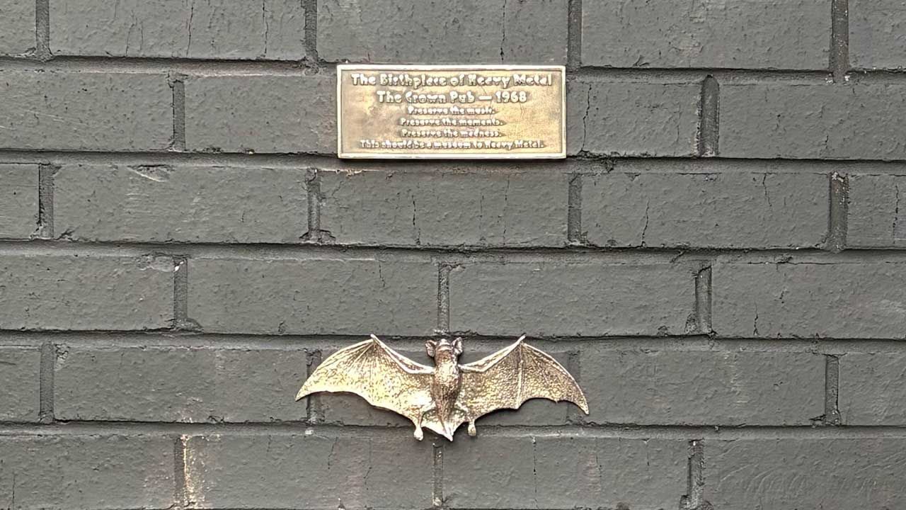 The brass plaque and bat attached to the wall of The Crown, Birmingham