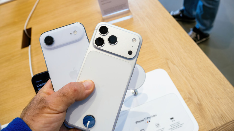 Man holding an iPhone Air and iPhone 17 Pro