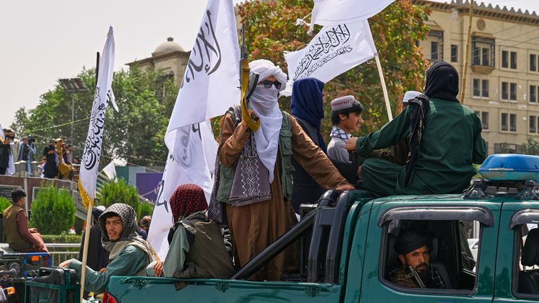 Taliban fighters ride on a pickup truck during celebrations marking the fourth anniversary of the US withdrawal. Pic: AP