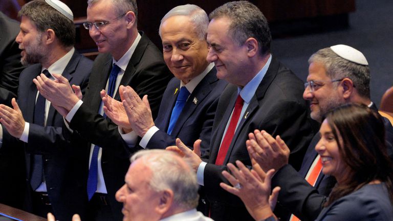 Benjamin Netanyahu applauds while Trump addresses the Knesset, Israel's parliament. Pic: Reuters 