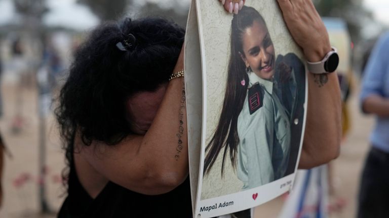 A woman leans on a picture of Mapal Adam, at the site of the Nova music festival. File pic: AP