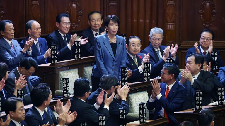 The new prime minister stands and bows after the vote. Pic: AP 