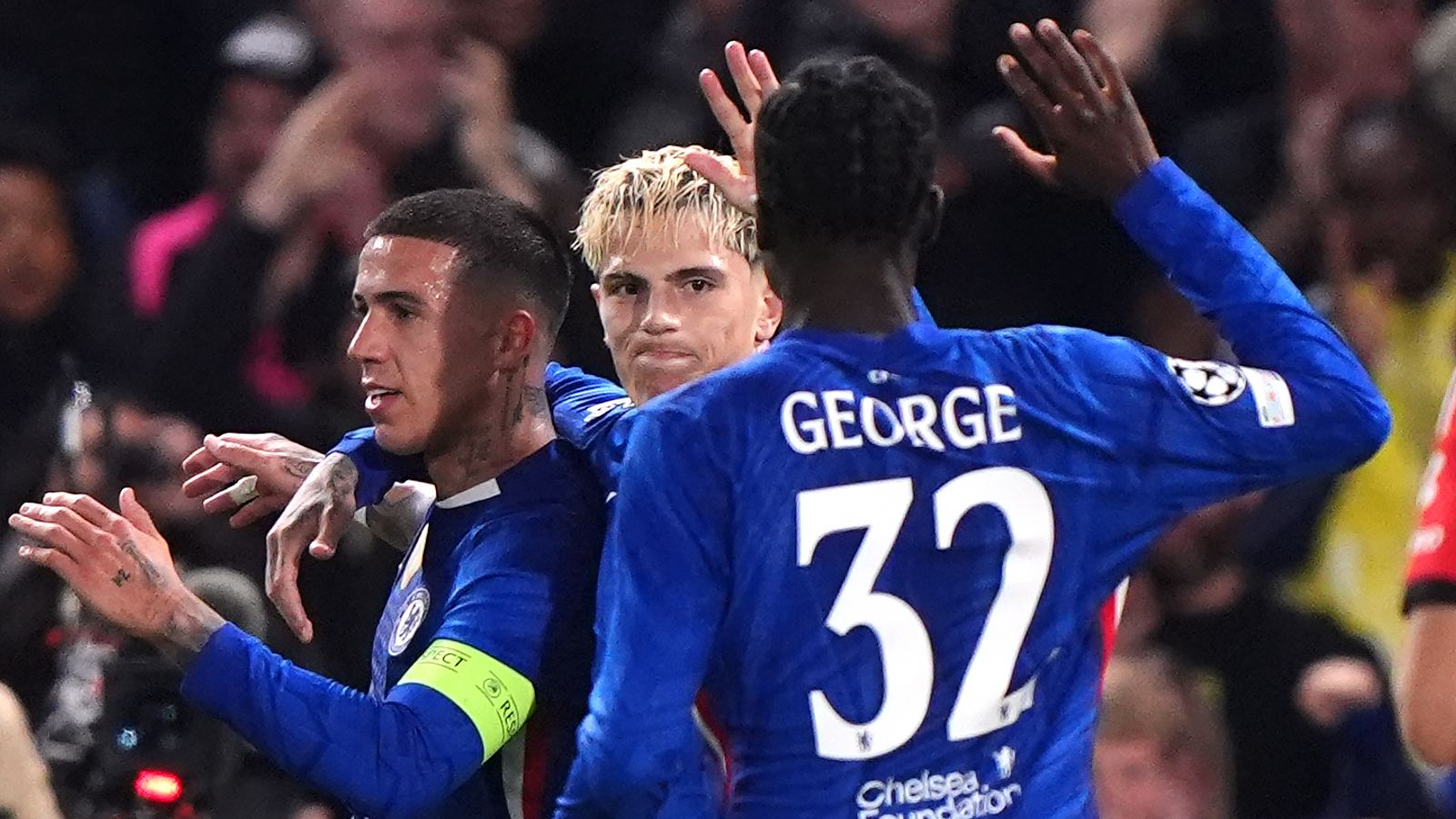 Chelsea players celebrate their opening goal against Benfica, an own goal scored by Richard Rios