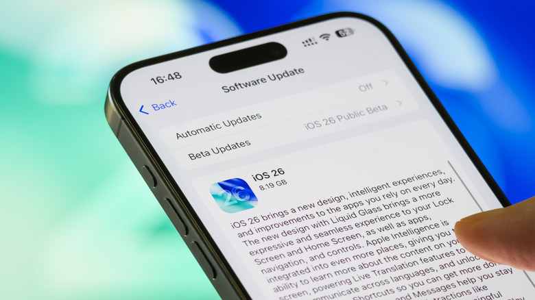 person updating iphone to ios 26
