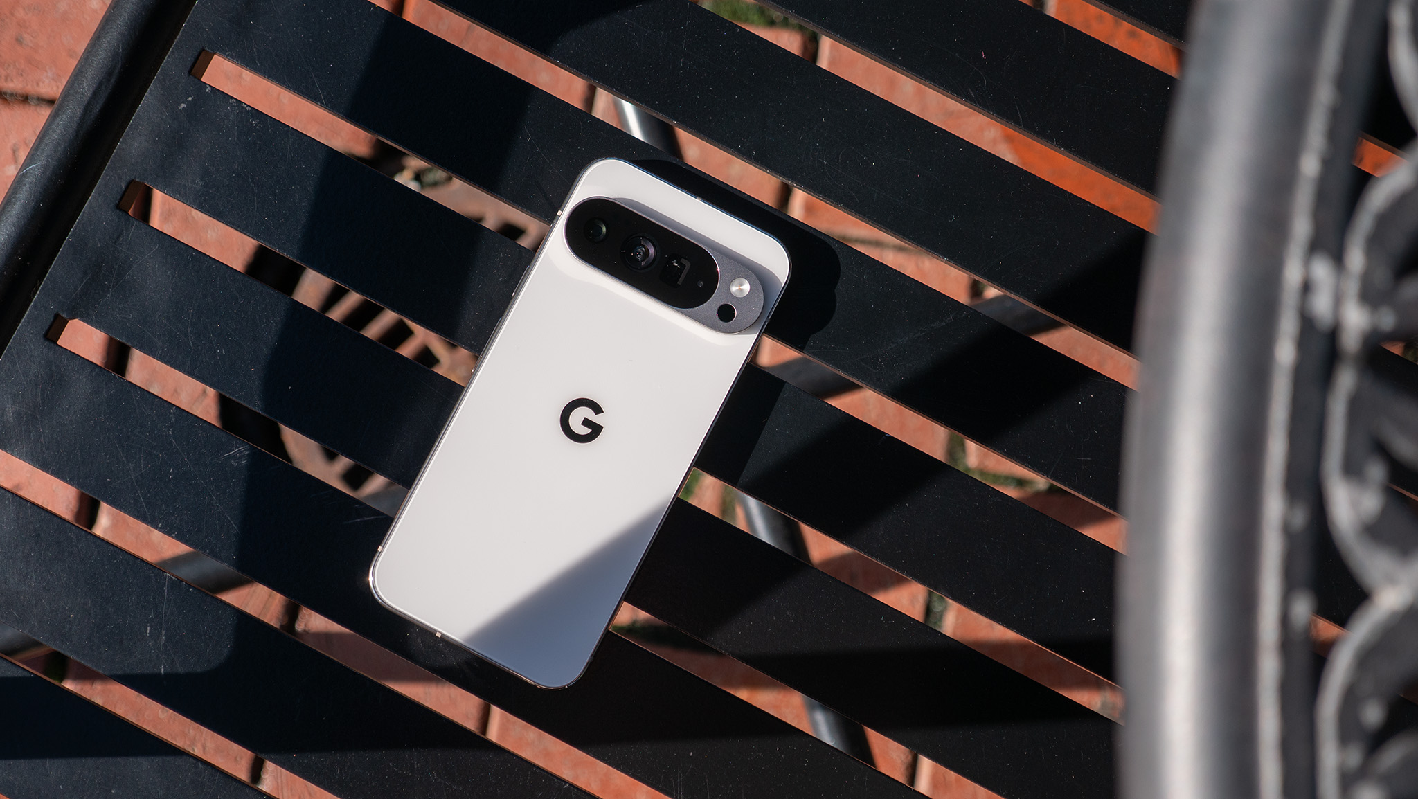 A white Google Pixel 10 Pro XL on a latticework black chair