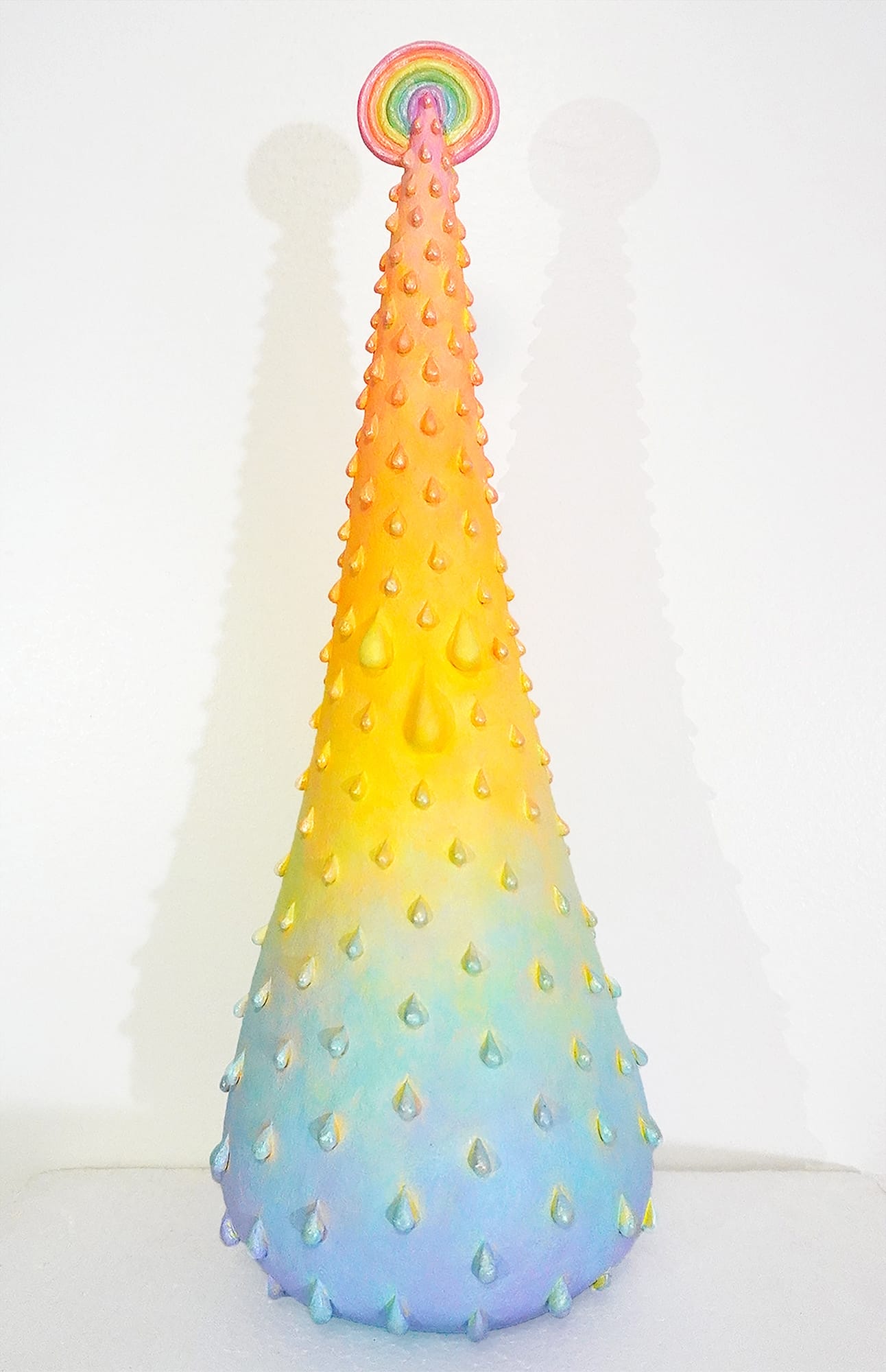 a rainbow colored water droplet emerging from a tiny spot by Yen Yen Chu