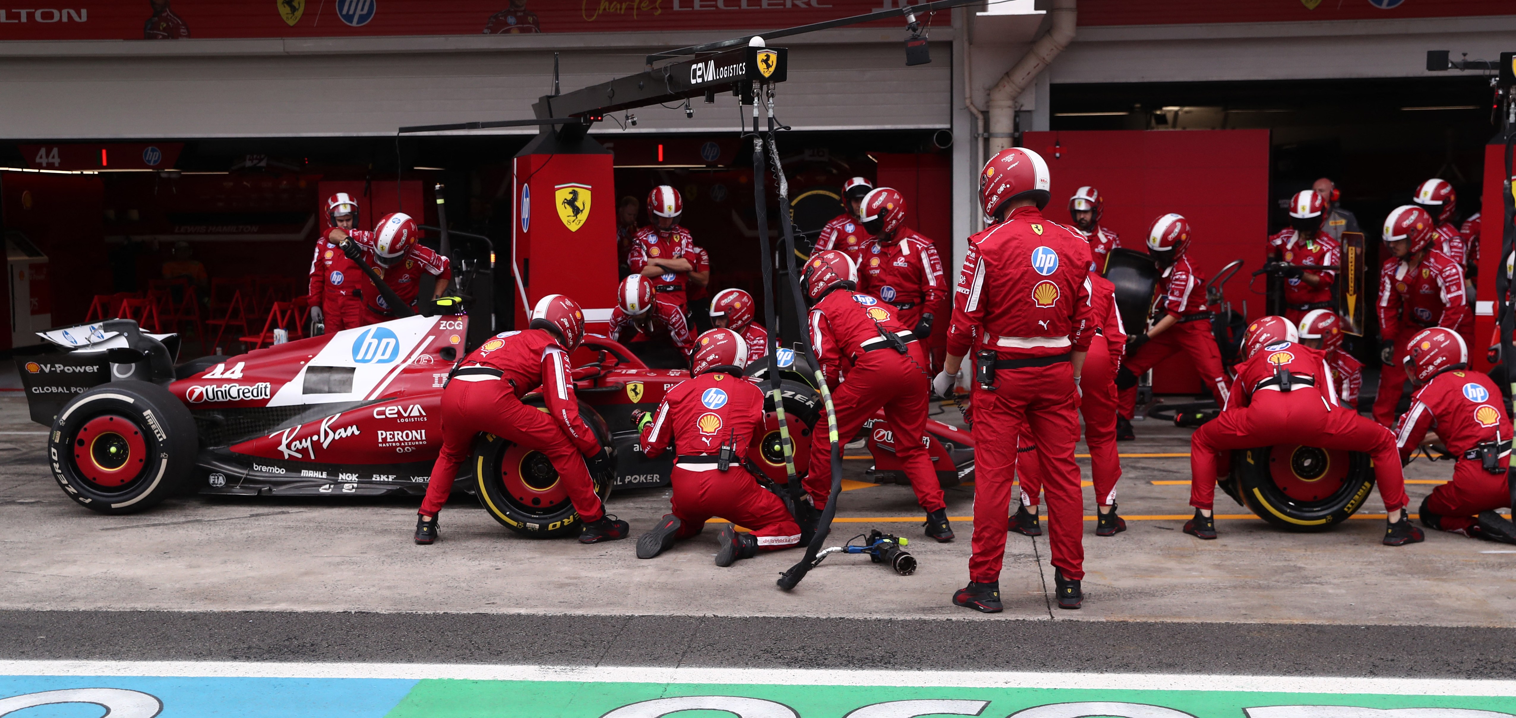 Ferrari's Lewis Hamilton in a pit stop with a team of mechanics during the Sao Paulo Formula One Grand Prix.