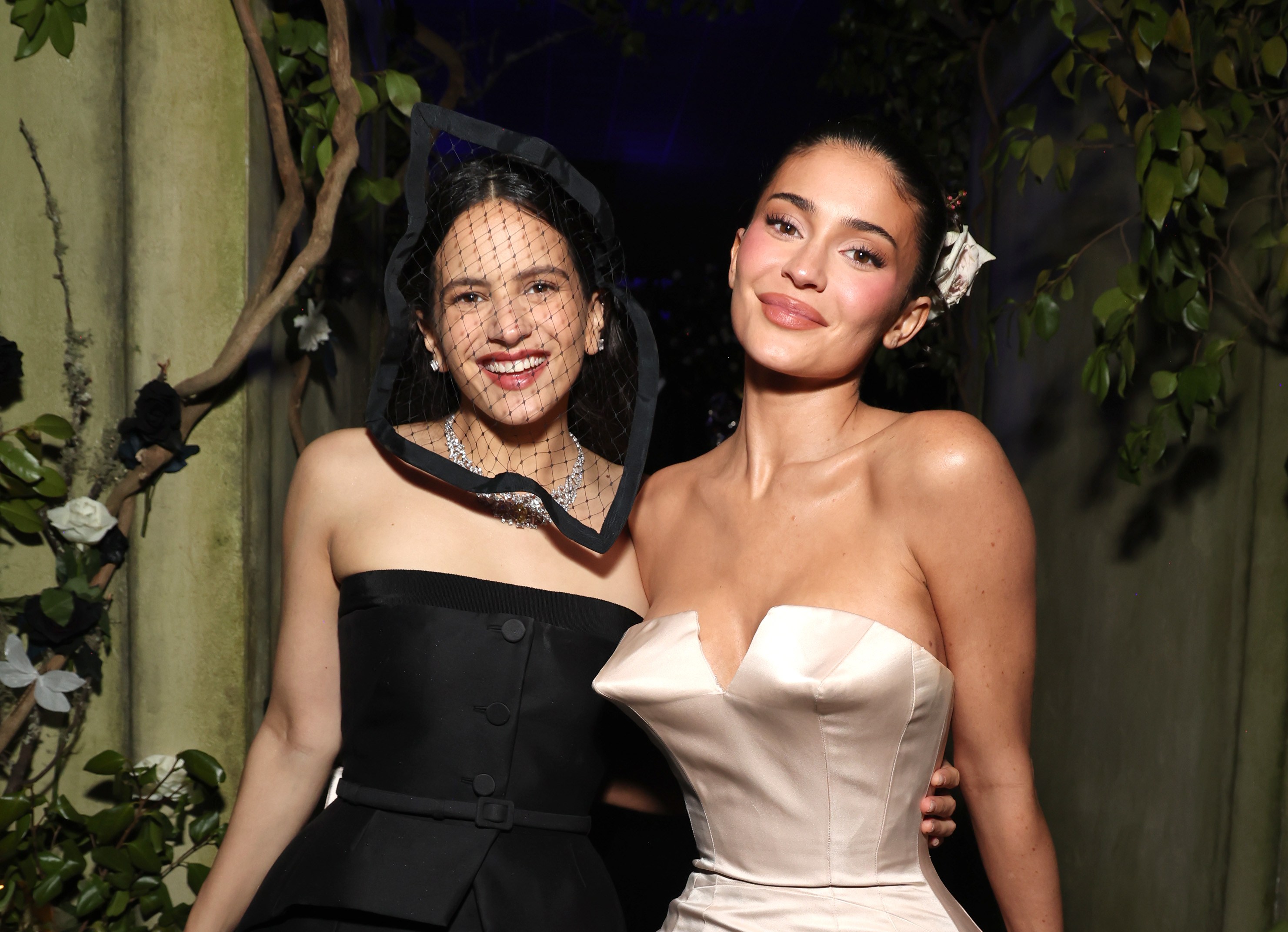 Rosalía in a black dress and Kylie Jenner in a cream dress posing at the Met Gala.