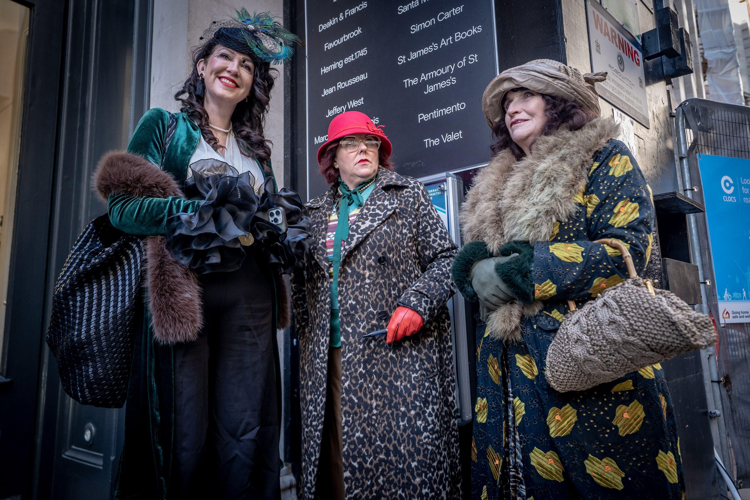 Three women in period attire participating in The Grand Flaneur Winter Walk.