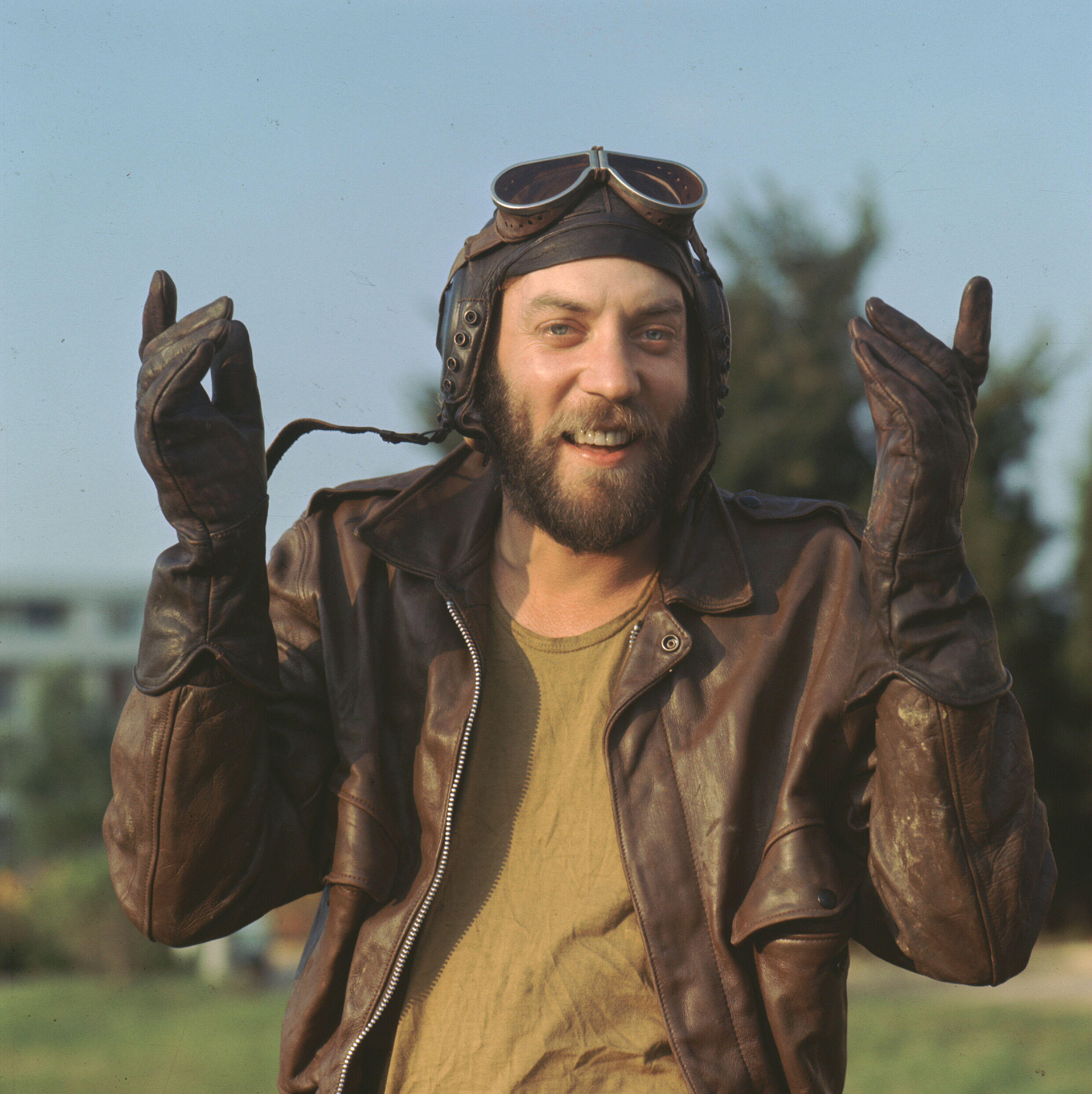 Donald Sutherland as Capt. Oddball in 'Kelly's Heroes' wearing a pilot's helmet and goggles and a brown leather jacket.