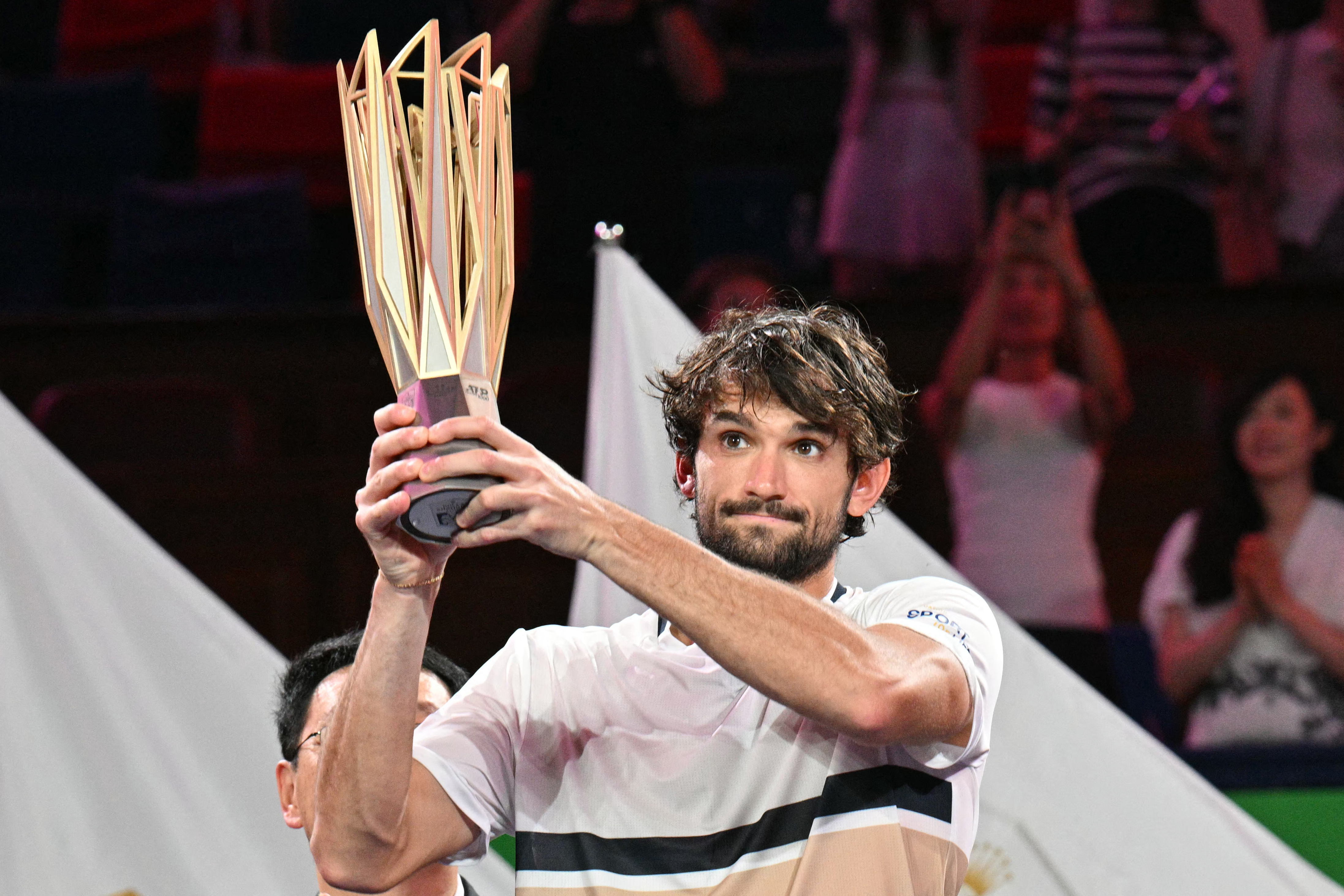 Monaco's Valentin Vacherot holds up the Shanghai Masters tennis tournament trophy.