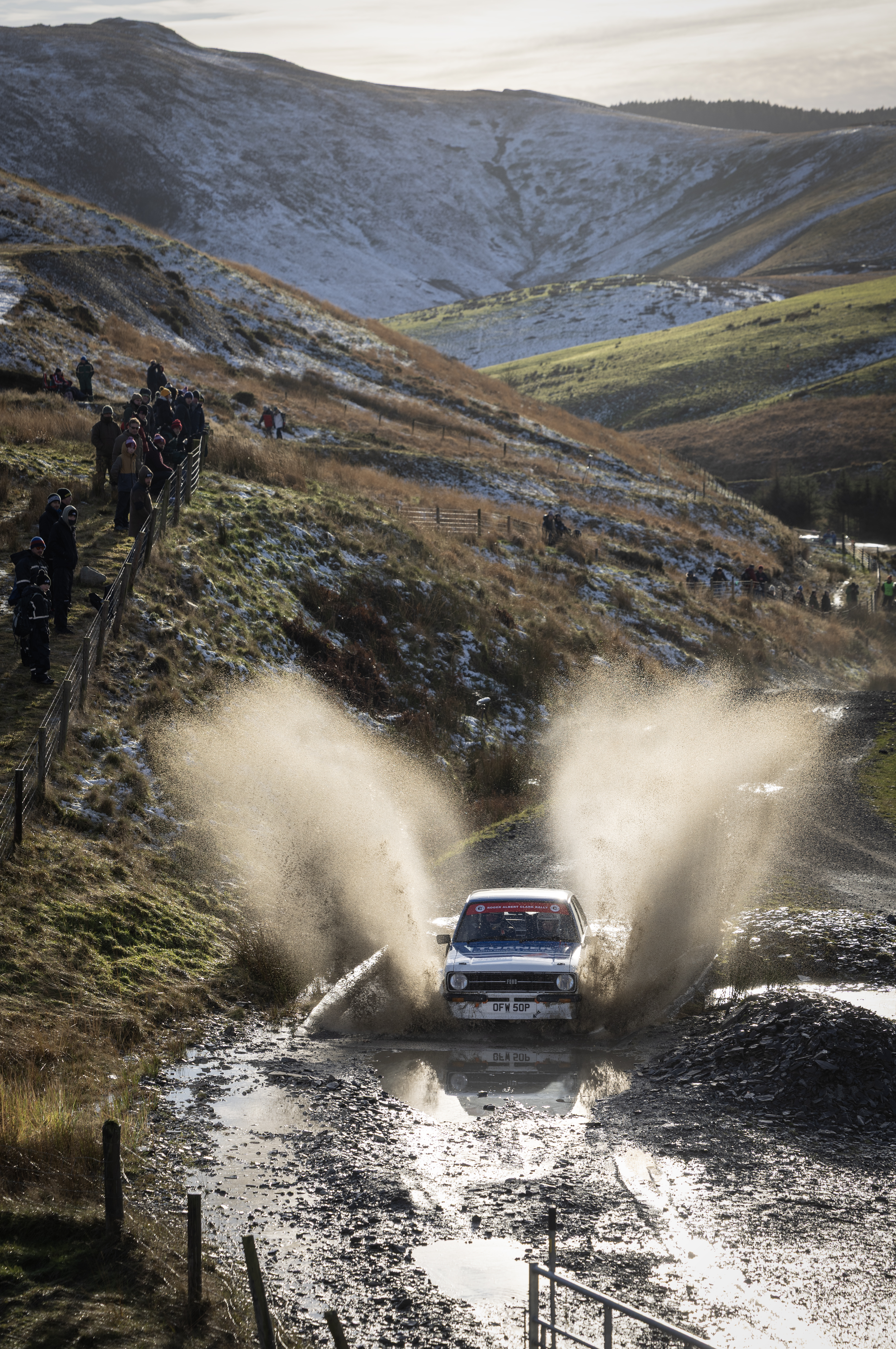 A rally car charging through a water splash at Sweet Lamb during the Roger Albert Clark Rally.