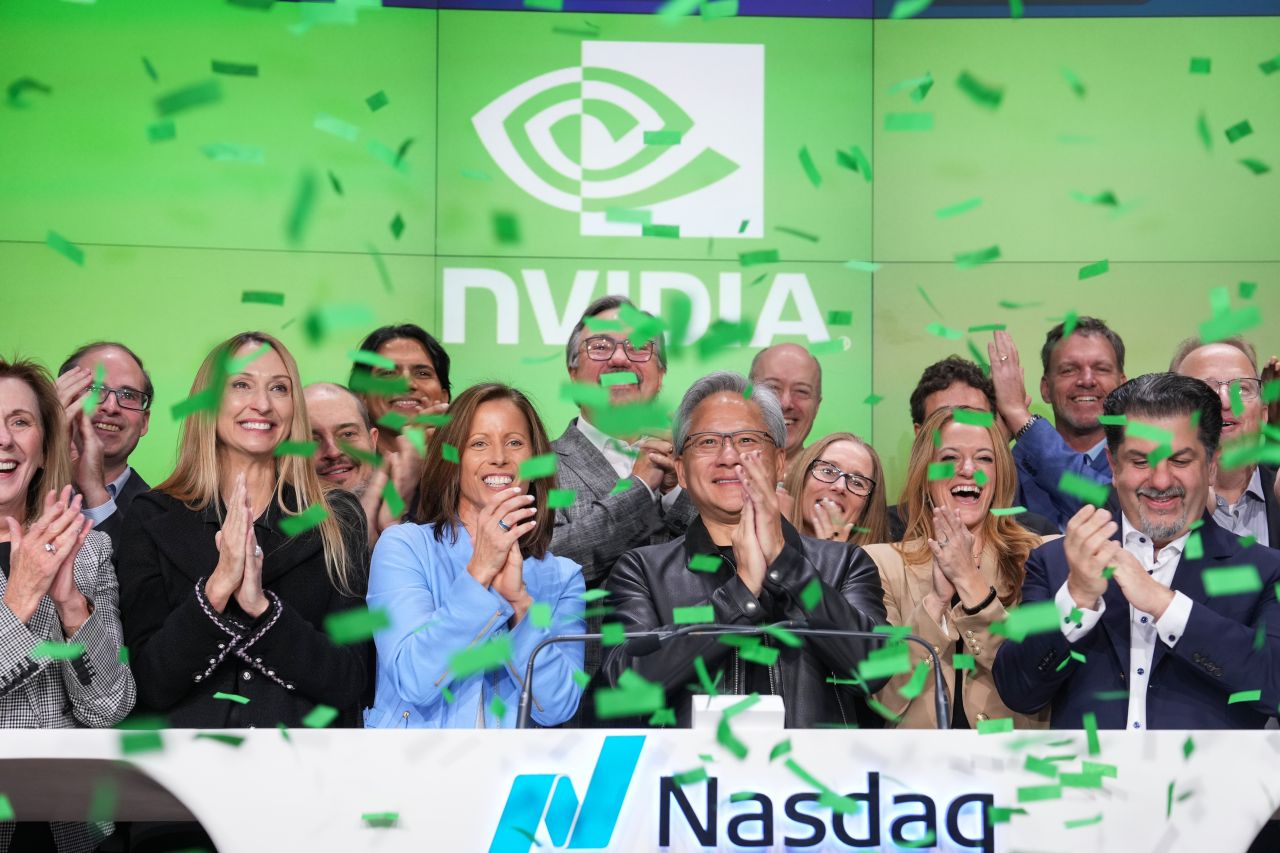 Jensen Huang and others celebrating with confetti falling and the NVIDIA logo in the background.