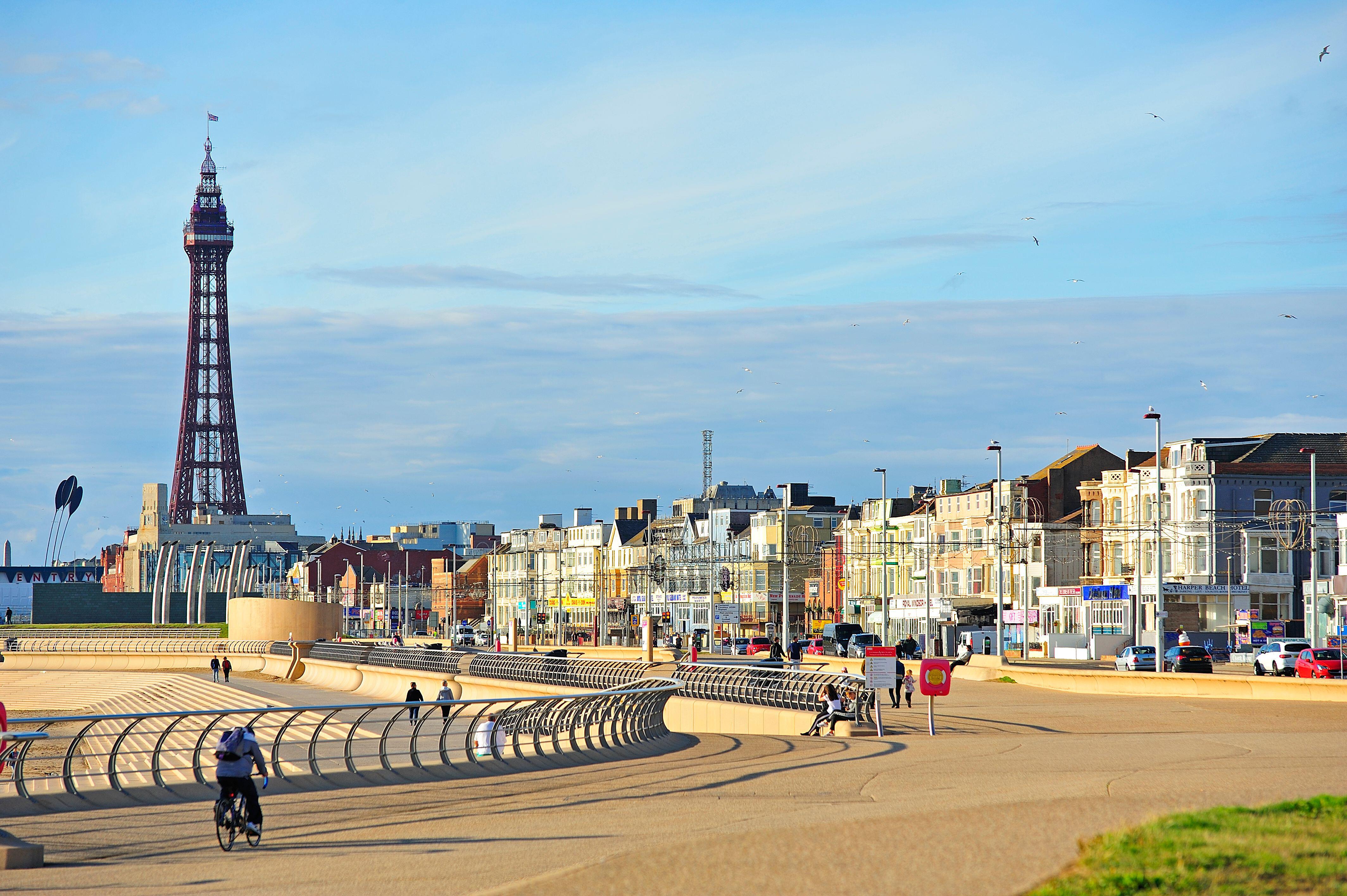Blackpool Tower, seawall, and colorful hotels on the seafront.