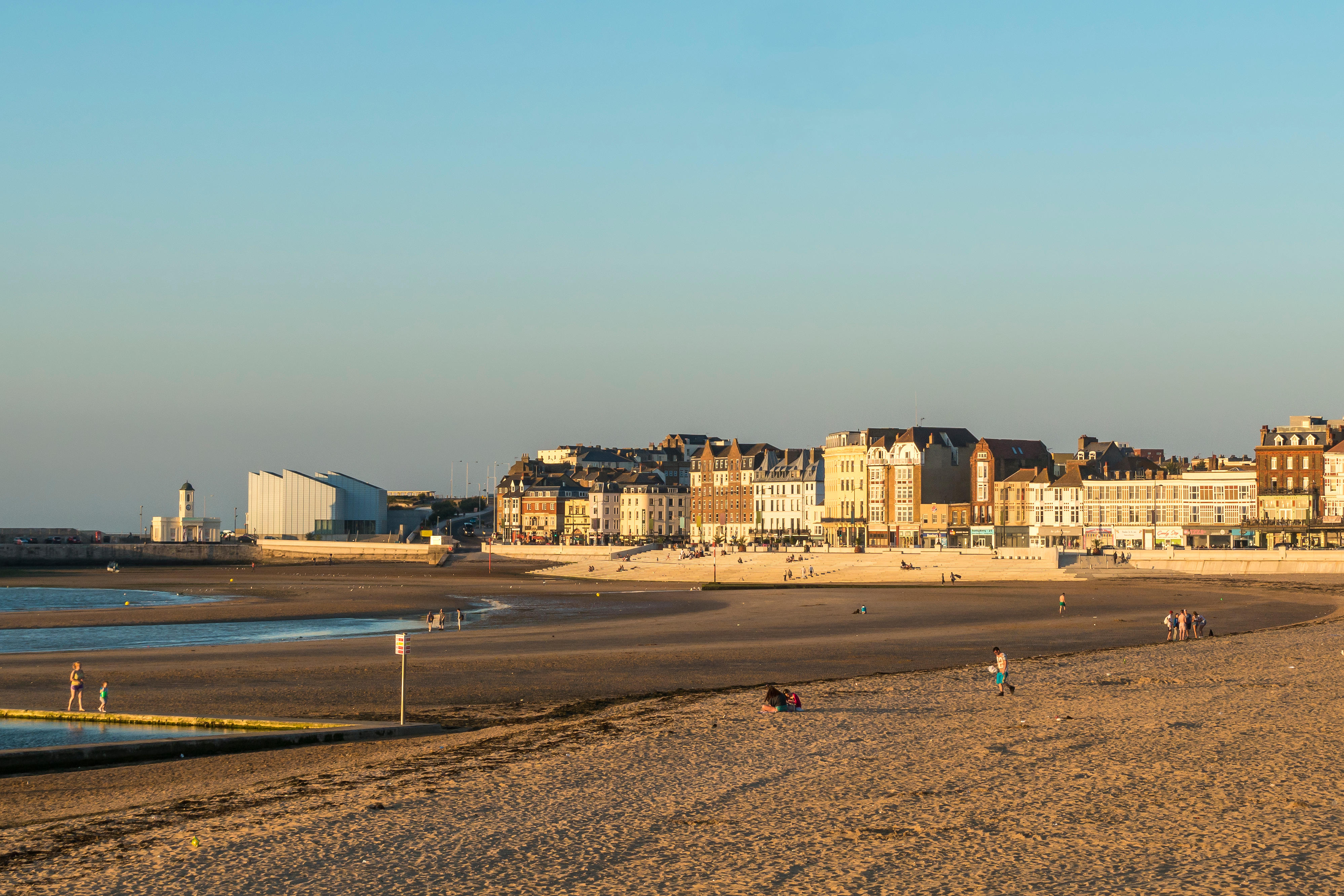 Margate Seafront with the Turner Centre, sands, and buildings during evening light.
