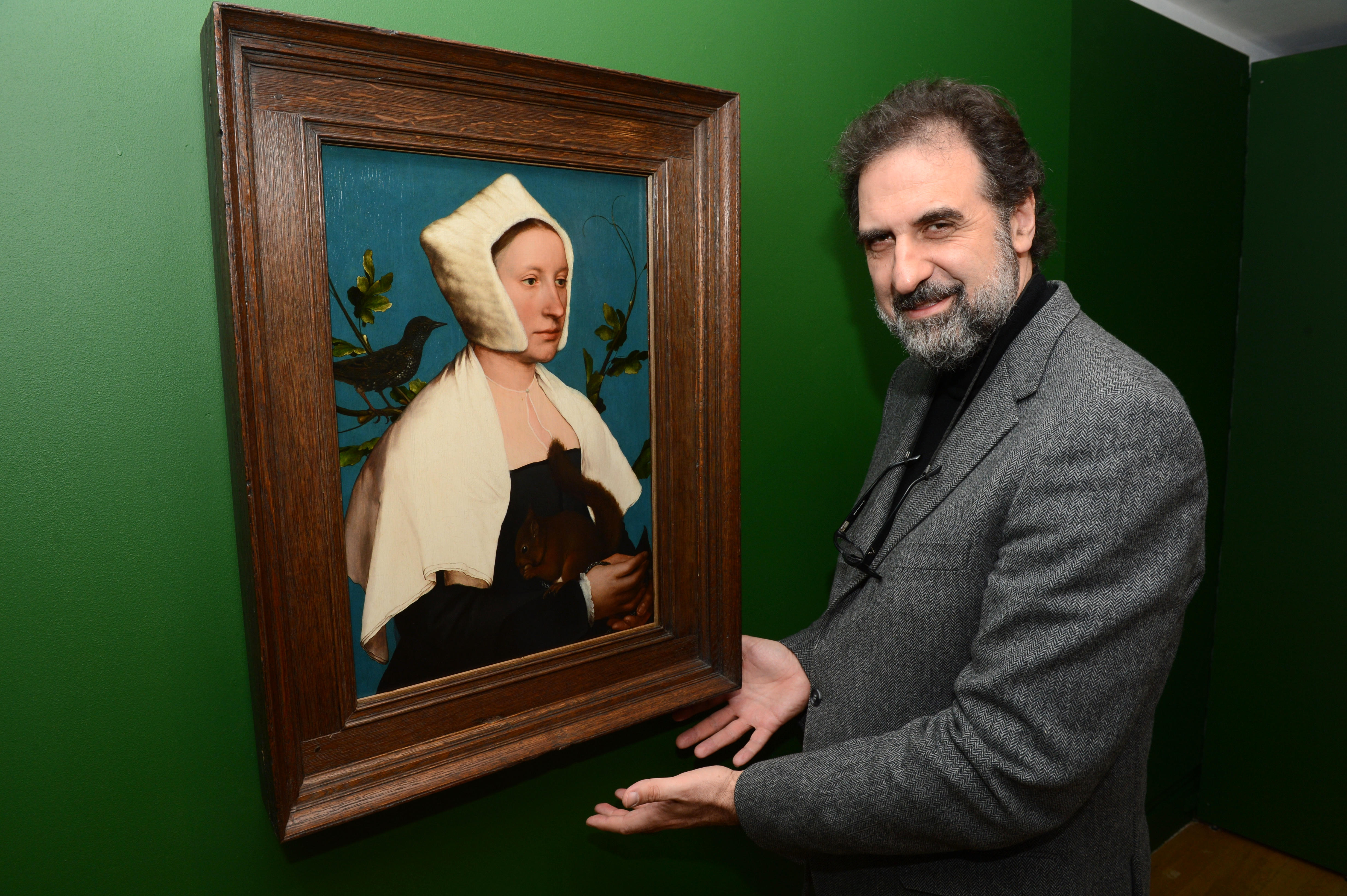 The National Gallery director Gabriele Finaldi next to Hans Holbein's painting, "A Lady with a squirrel and a starling."