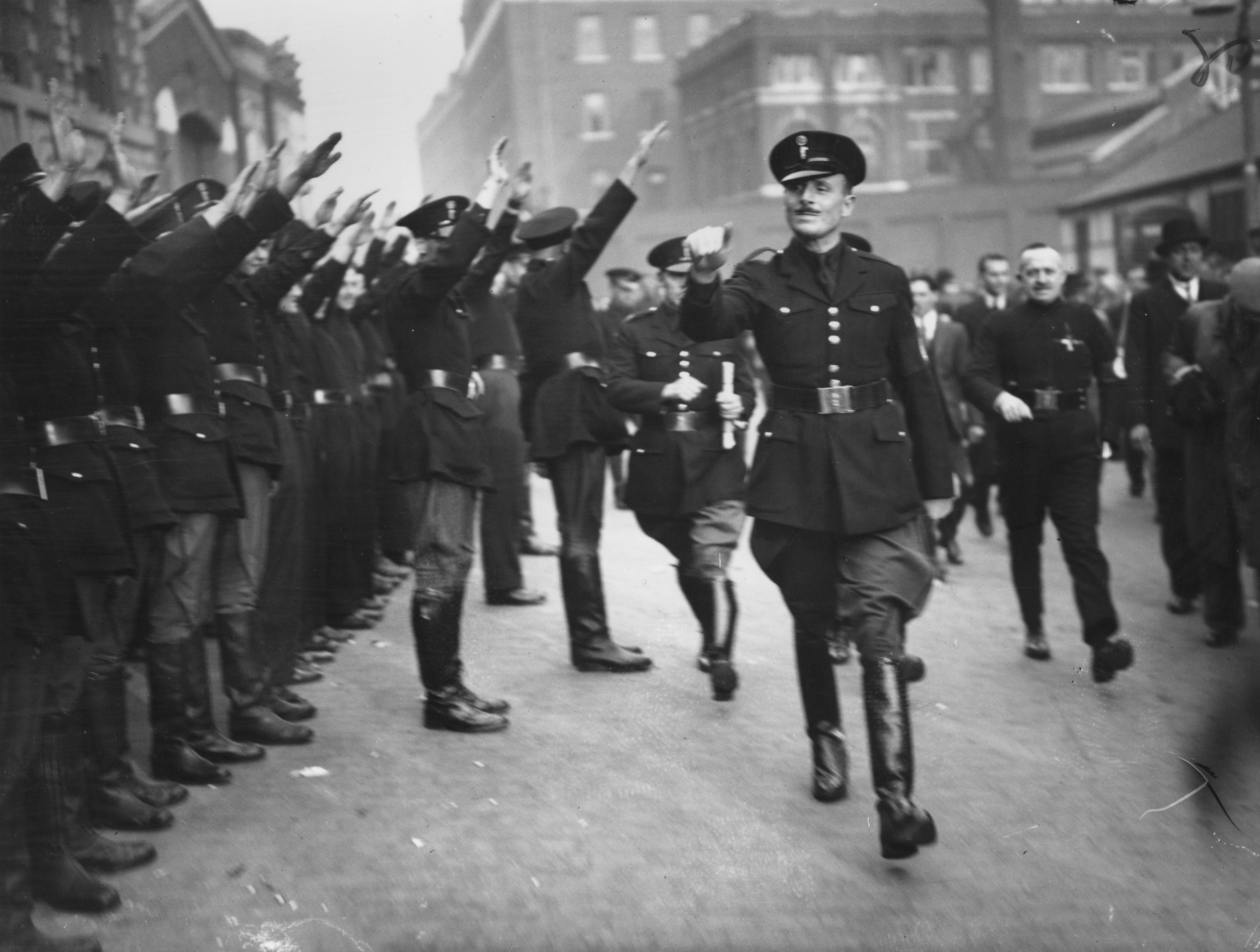 Sir Oswald Mosley, leader of the British Union of Fascists, being saluted at a fascist parade.