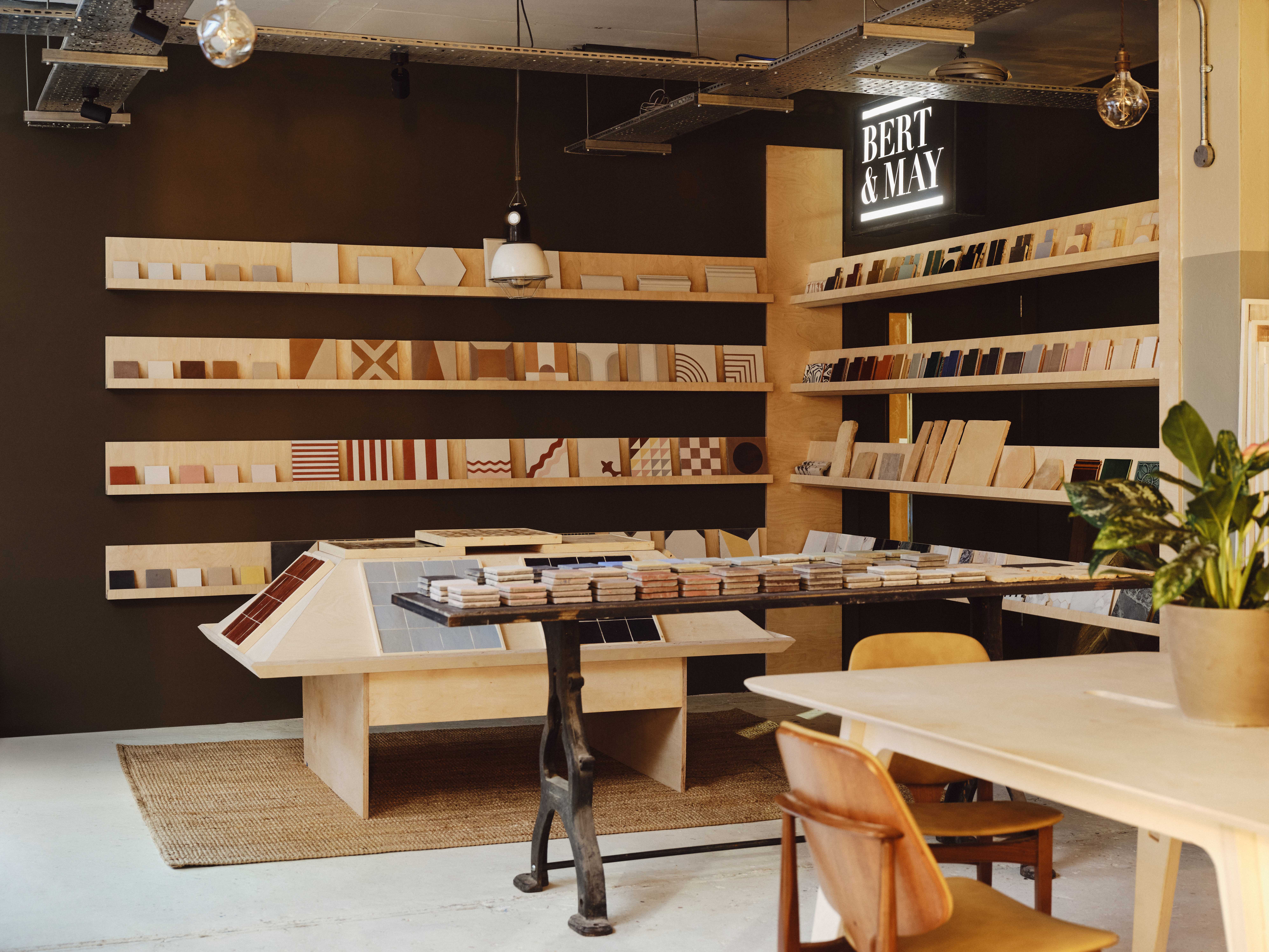 Interior design space, "The Mix" by Bert and May, with shelves displaying various tile samples and other decor items.