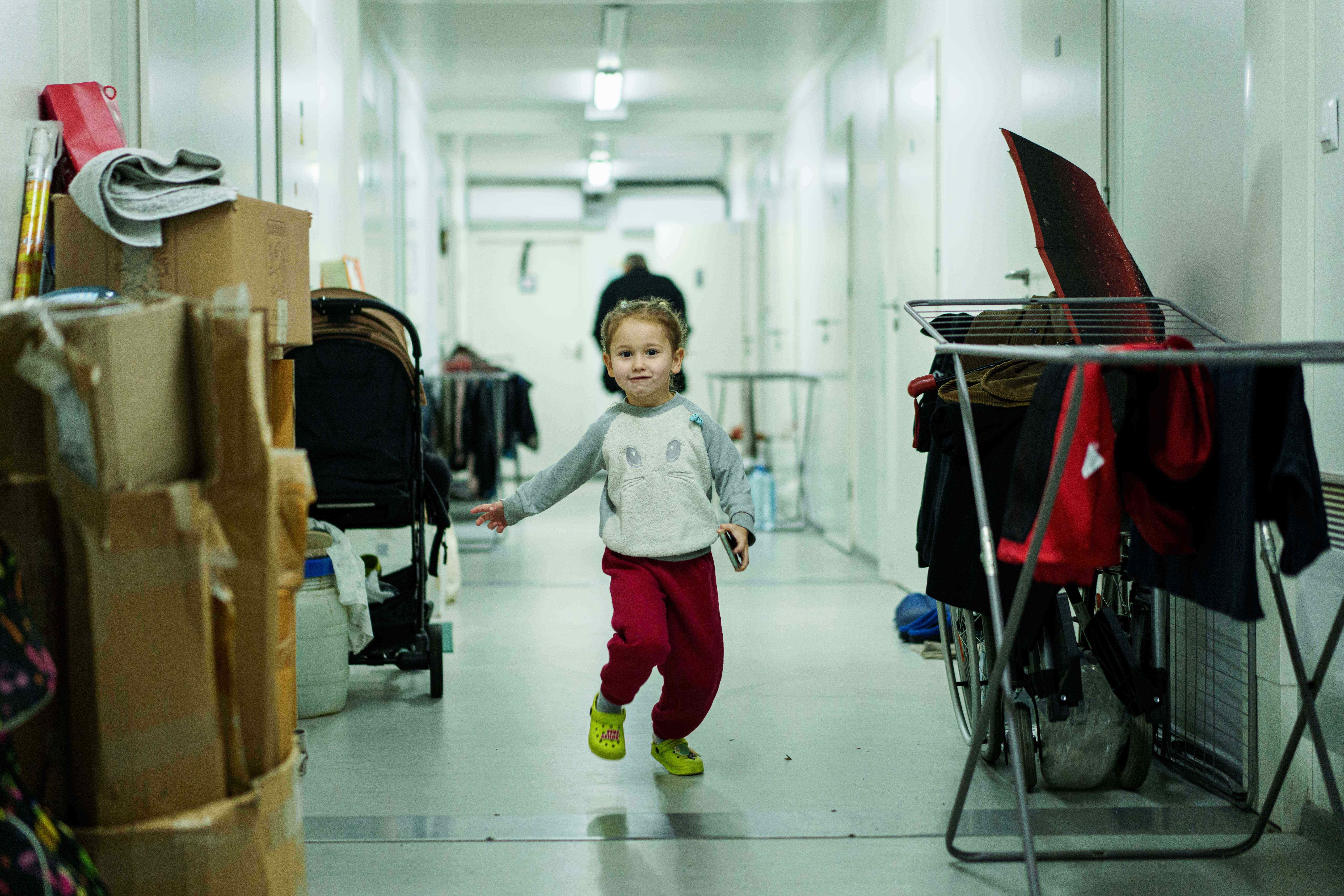 Ieva, 5, runs along a corridor at a hostel for internally displaced people in Bucha, Ukraine.