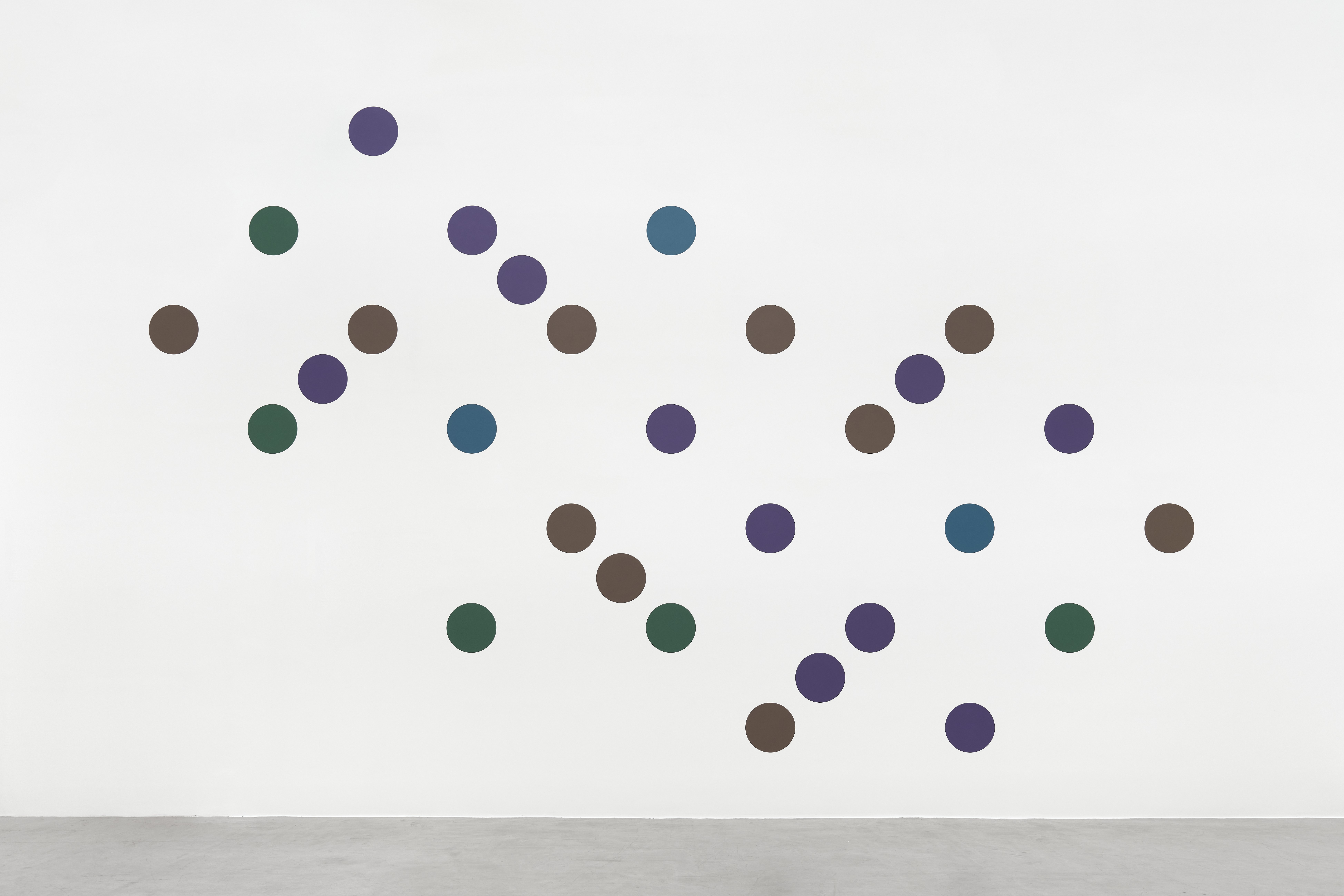 Dancing to the Music of Time, a Bridget Riley artwork with green, brown, blue, and purple circles arranged on a white wall.