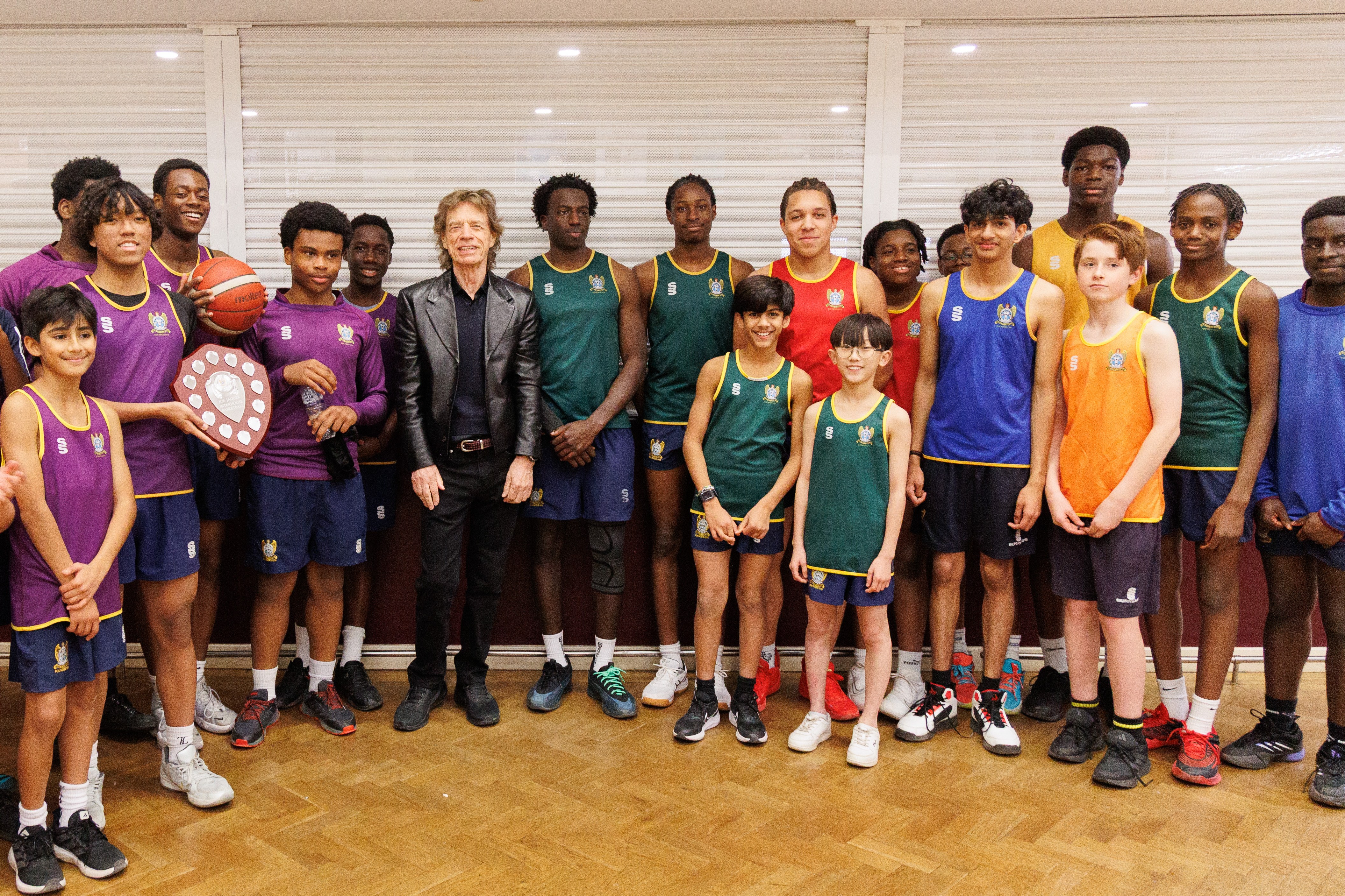 Sir Mick Jagger presenting a trophy to the current basketball team at Dartford Grammar.