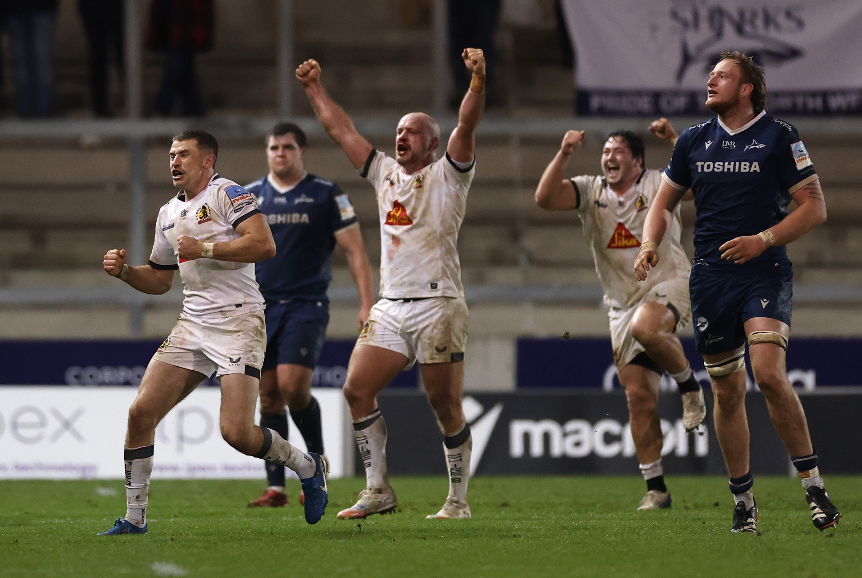 Harvey Skinner and his Exeter teammates celebrate their win over Sale Sharks during a rugby match.