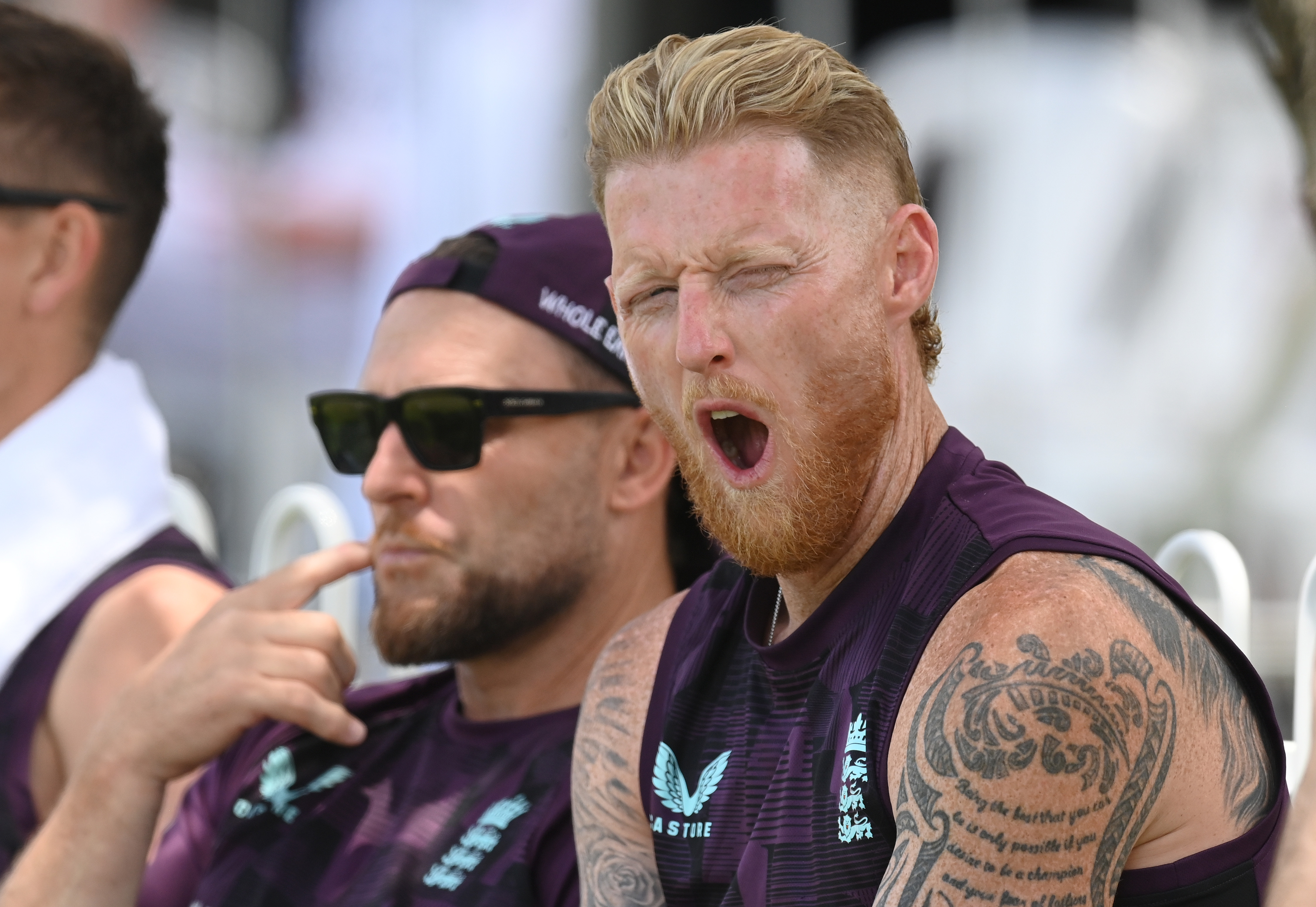 Ben Stokes yawns next to Brendon McCullum during a cricket practice match.