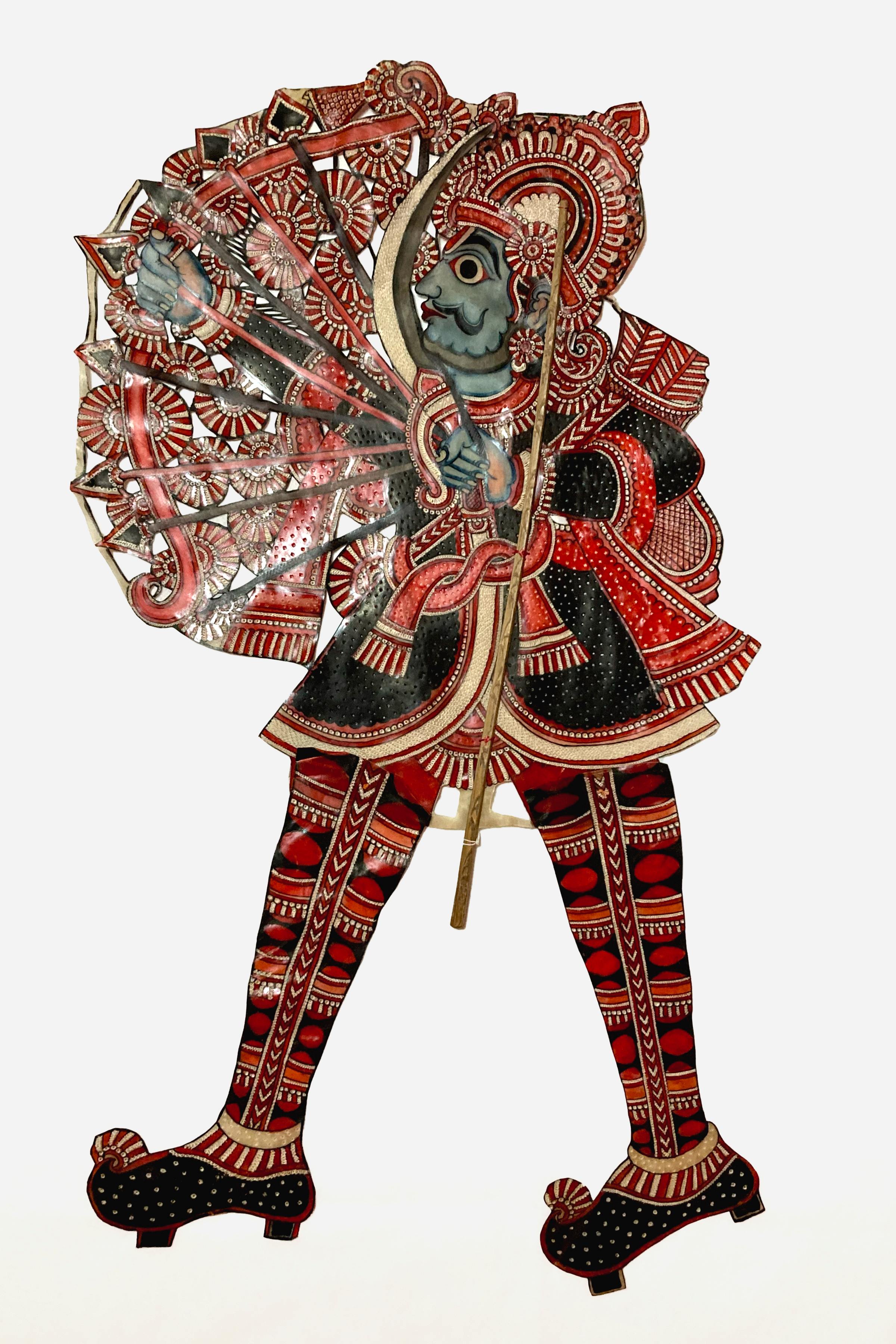 Illustration of a shadow puppet from Andhra Pradesh, India, showing a blue-skinned figure with black and red attire, holding a bow and arrow.