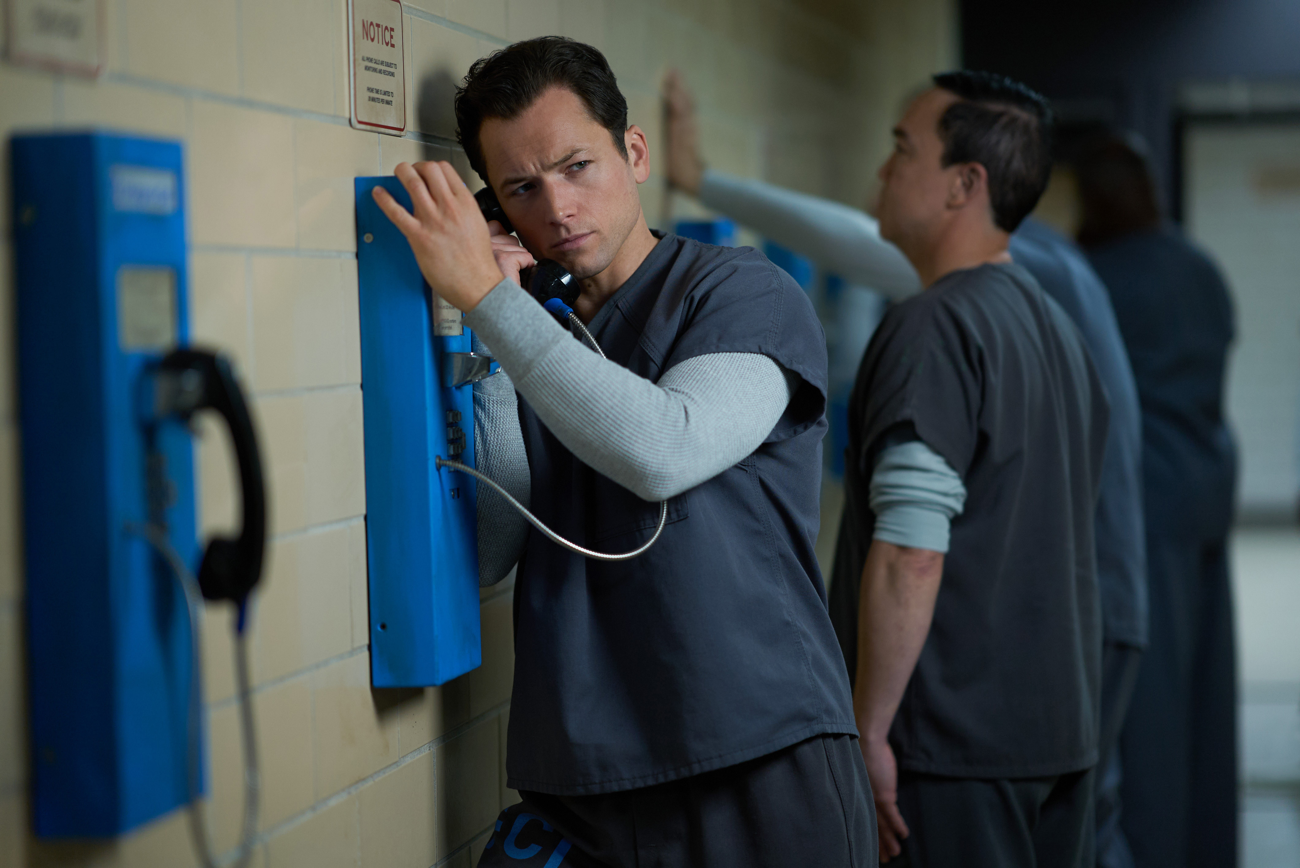 Taron Egerton on a prison phone in a still from "Black Bird."