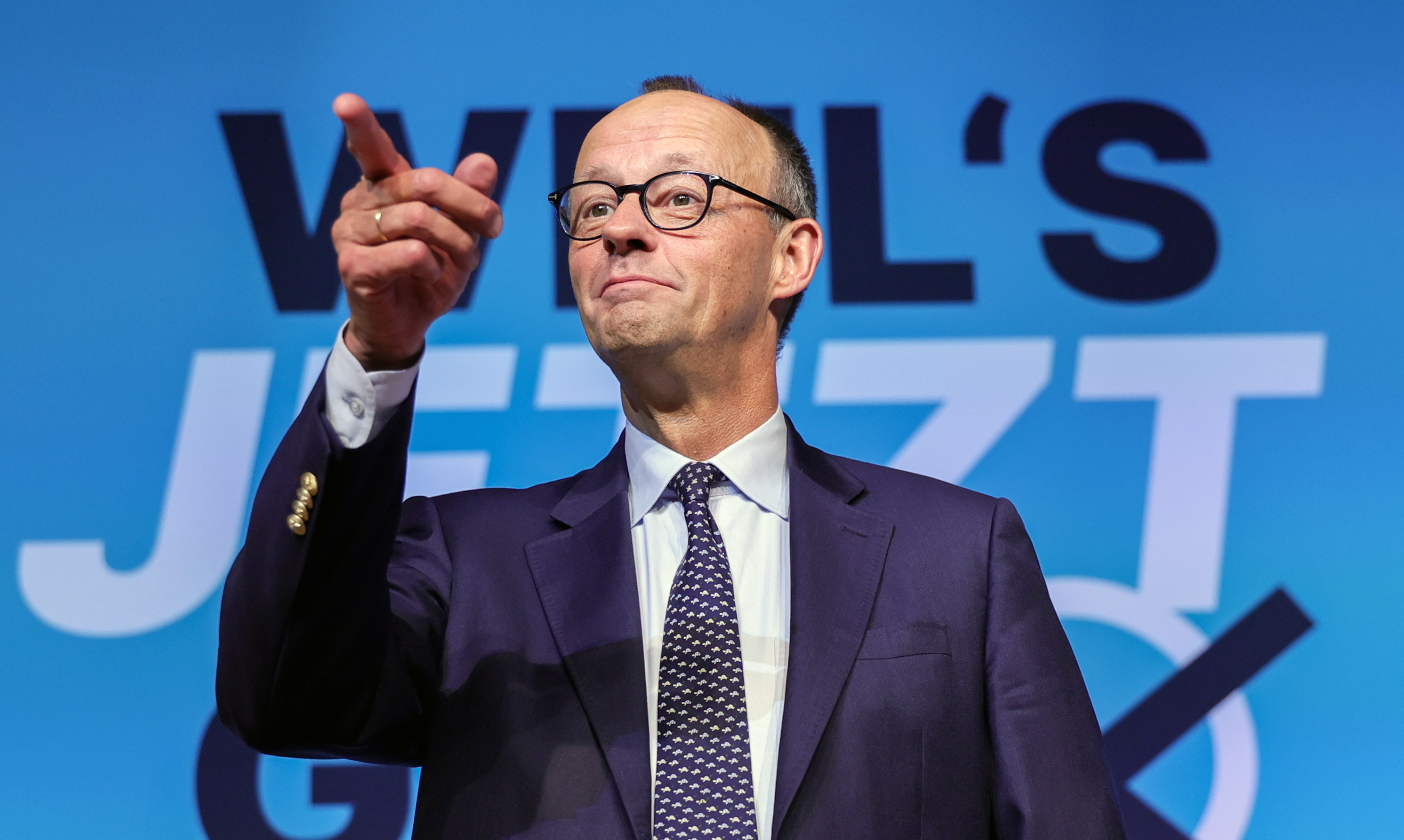 Friedrich Merz, leader of the CDU, gestures during a party conference.