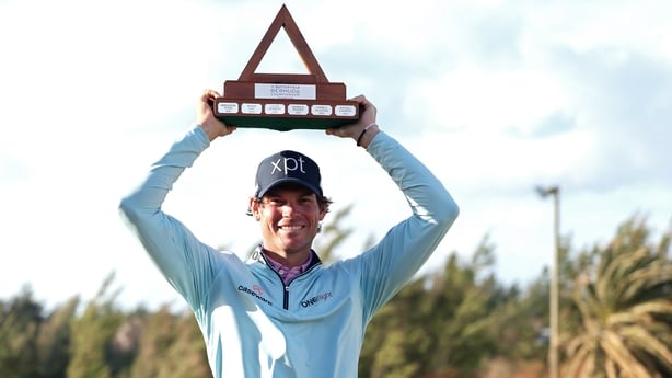Adam Schenk of the United States poses with the winner's trophy after winning the Butterfield Bermuda Championship 2025 at Port Royal Golf Course on November 16, 2025 in Southampton, Bermuda.