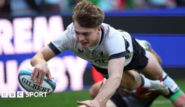 Jack Bracken dives over the line with his arm outstretched holding the ball to score a try for Saracens