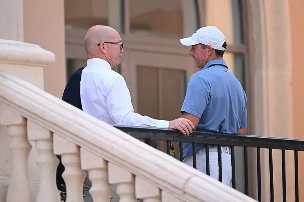 Guy Kinnings, Chief Executive Officer of the European Tour Group speaks with Rory McIlroy of Northern Ireland in the clubhouse prior to the DP World Tour Championship 2025