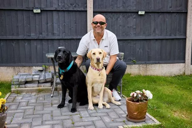 Wayne with his guide dogs