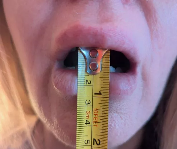 Naomi showing the 14mm opening with a tape measure