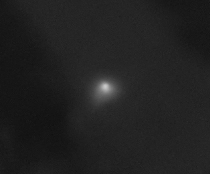 On a largely black background, interstellar comet 3I/ATLAS appears as a white smudge with a semicircular shape at its core. Credit: NASA/JPL-Caltech/University of Arizona