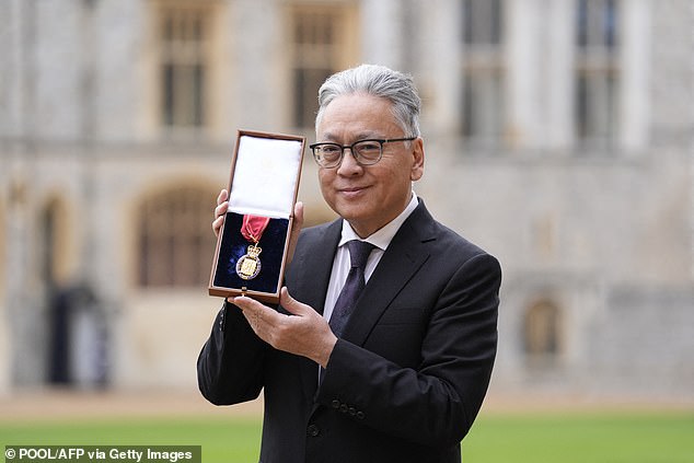 The Japanese-born British author (pictured with his medal following his appointment) has revealed his books have been 'raided' to train artificial intelligence models