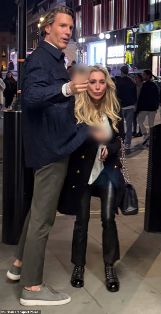Police released this photo of two people they want to talk to after a family was allegedly racially abused and assaulted in central London (image blurred at source by British Transport Police)