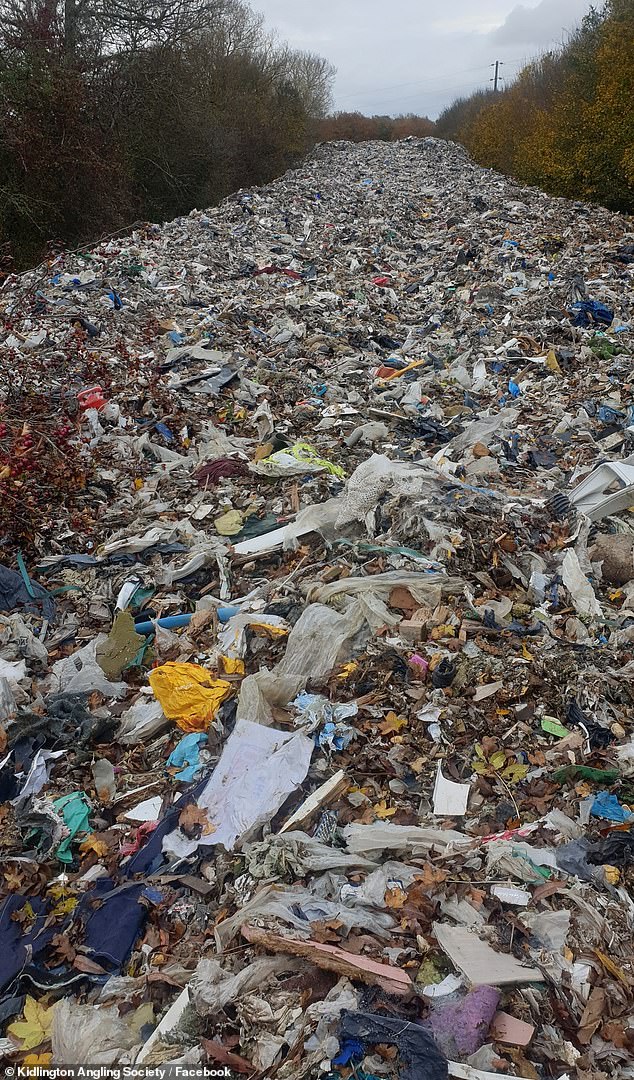 The 20ft-high pile of hazardous rubbish was illegally dumped in a field next to the A34 and River Cherwell near Kidlington in Oxfordshire