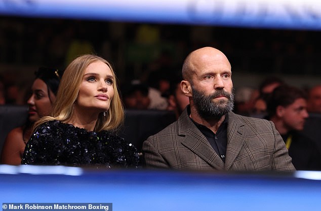 Statham and Huntington-Whiteley take their seats next to each other before the big fight