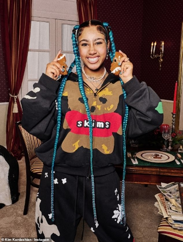 The child of rapper Kanye West was photographed in a pajama set for the holiday season while in a Christmas-decorated dining room. The budding star had none of the fake tattoos or piercings she donned last month for fun with her friends