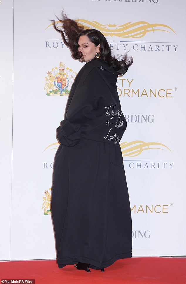 Jessie J didn't let the blustery weather dampen her spirits as she beamed while her dark locks were blown around on the red carpet at the Royal Variety Performance on Wednesday night.