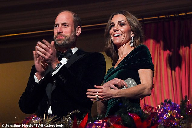 The couple applauded while Kate held her silver sparkly clutch bag