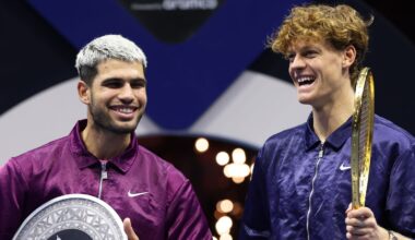Jannik Sinner of Italy (R) and Carlos Alcaraz of Spain share a joke after receiving their trophies after the Men's Single's Final on day thr